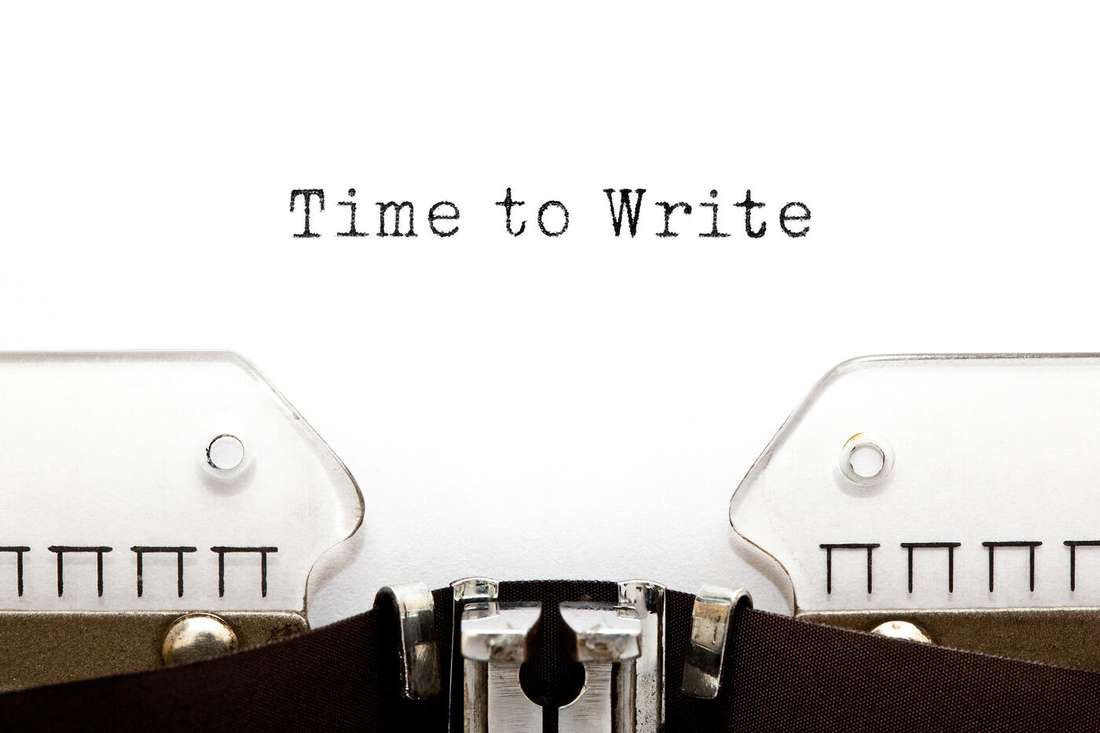 A vintage typewriter with the words Time to Write typed on the page