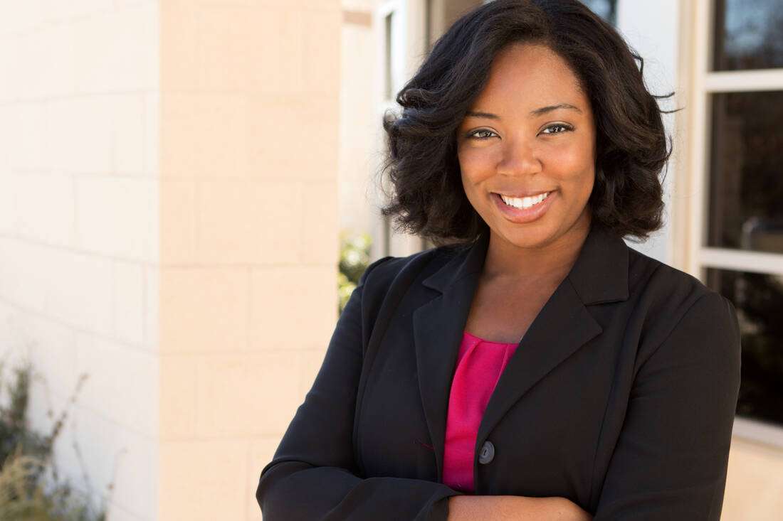 A smiling professional woman in a black blazer