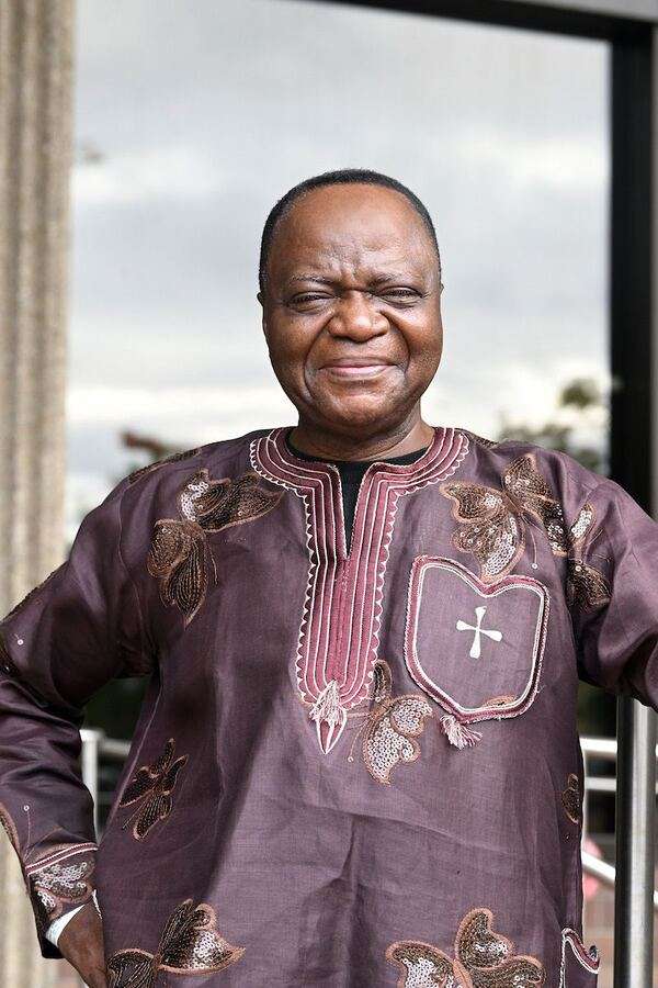 Dr. George J. Sefa Dei, smiling, in a patterned African shirt
