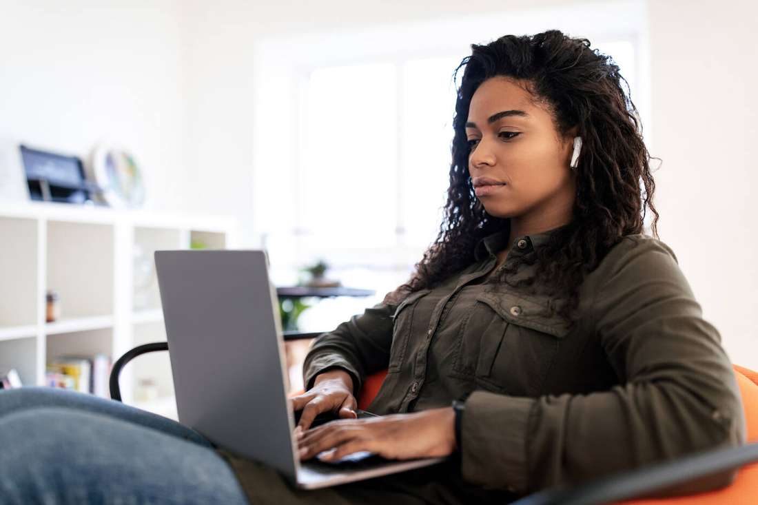 A woman focused on her laptop