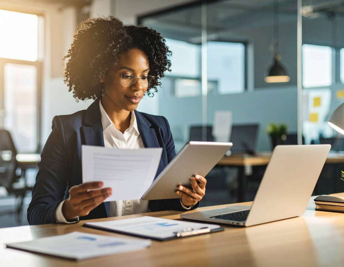 A professional woman reviewing documents in a bright office